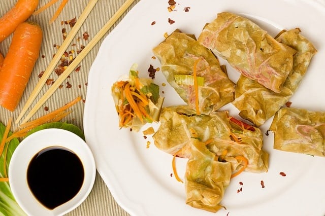 spring-rolls-on-a-plate-with-dark-liquid