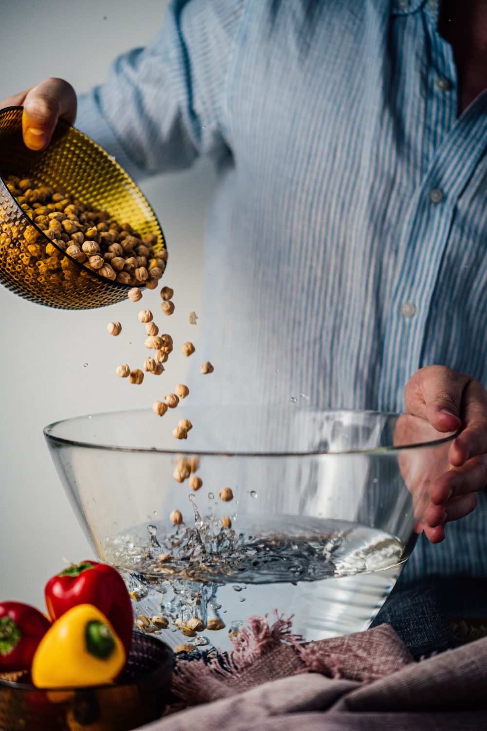 pouring-chickpeas-into-bowl-of-water