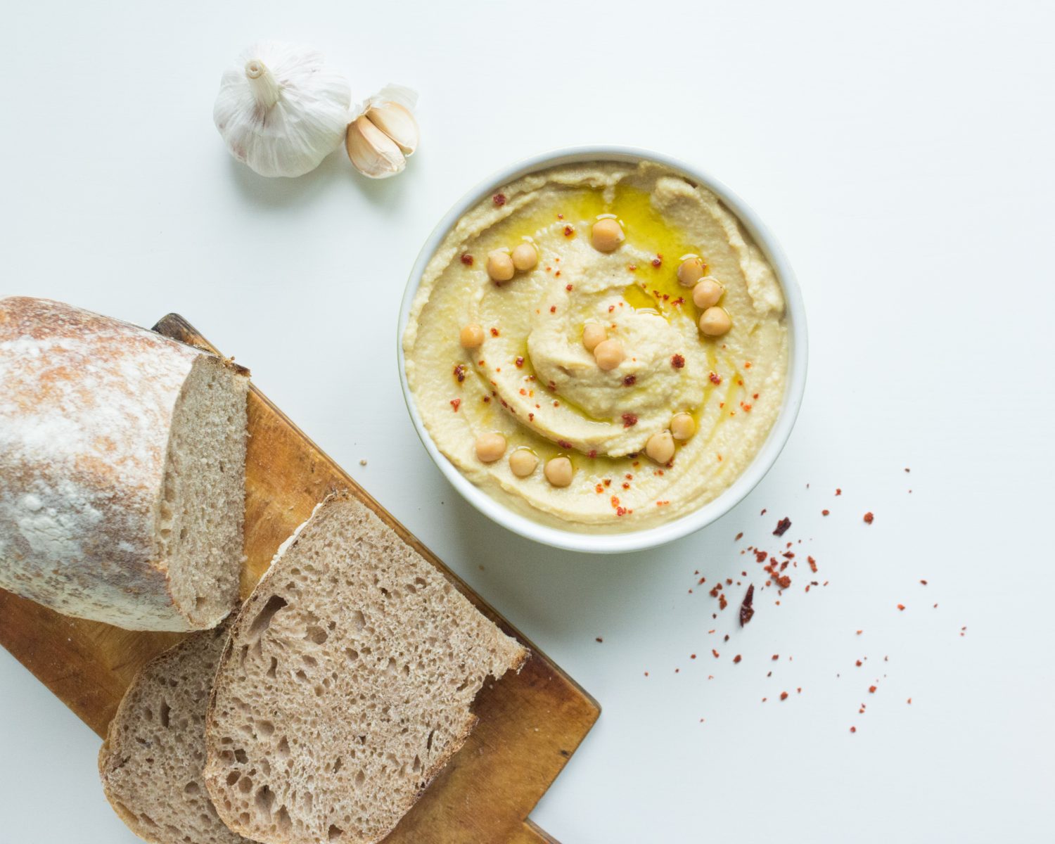 bowl-of-hummus-and-loaf-of-bread