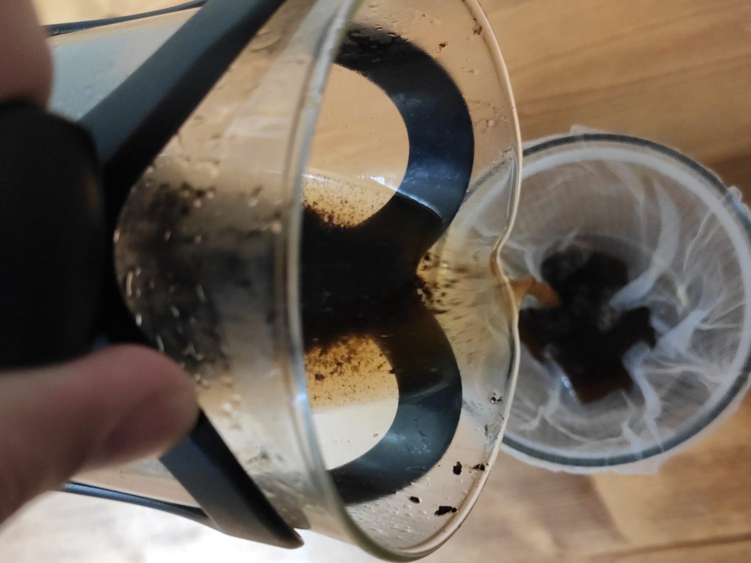 pouring-coffee-grounds-into-mesh-filter