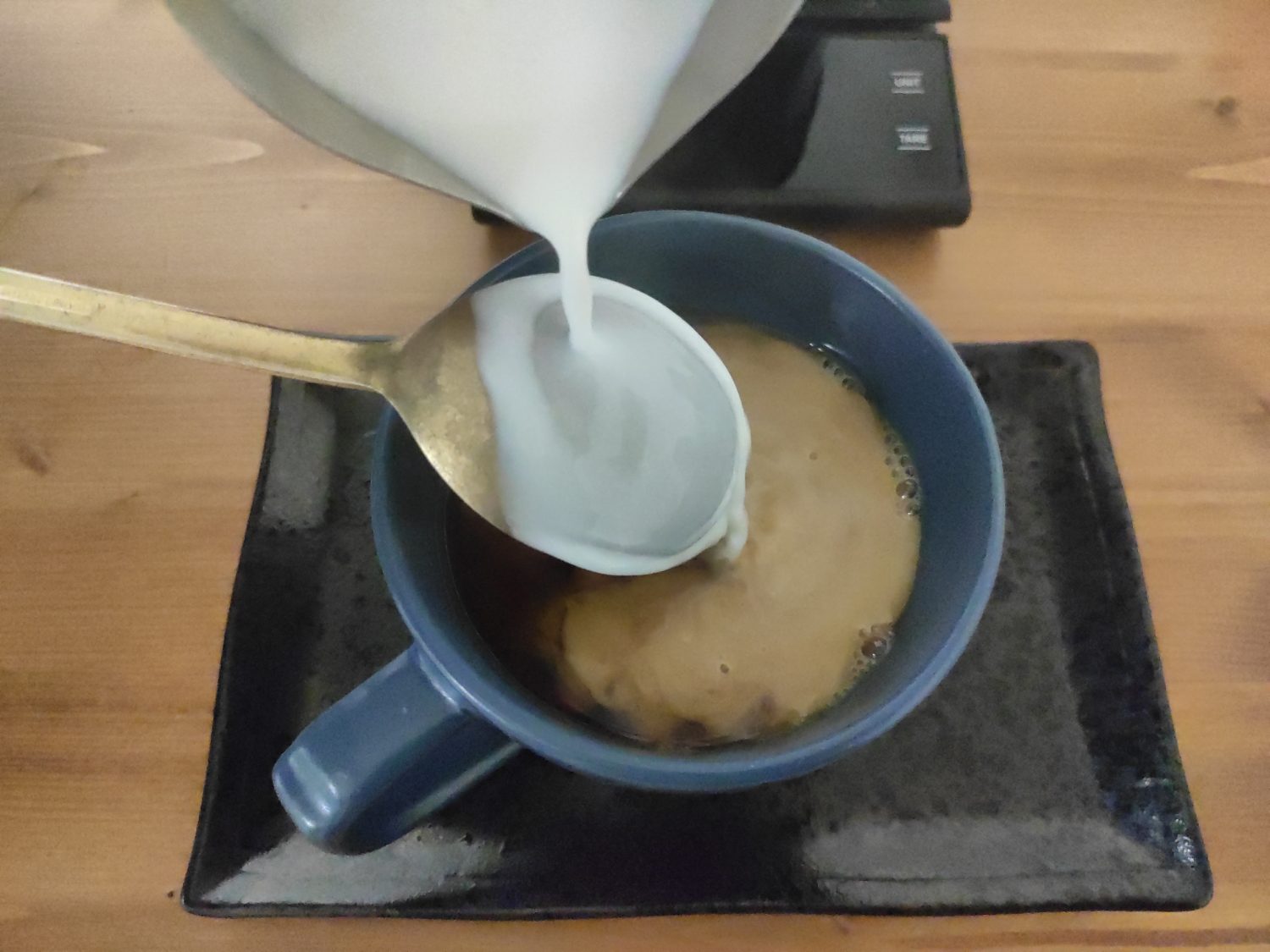 spooning-milk-into-latte